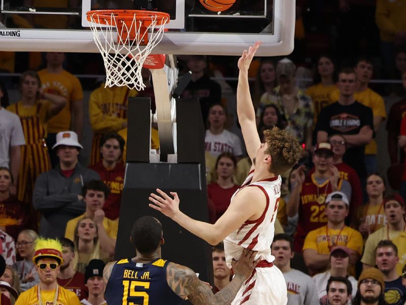 Feb 27, 2023; Ames, Iowa, USA; Iowa State Cyclones forward Aljaz Kunc (5) scores in front of West Virginia Mountaineers forward Jimmy Bell Jr. (15) during the first half at James H. Hilton Coliseum. Mandatory Credit: Reese Strickland-USA TODAY Sports