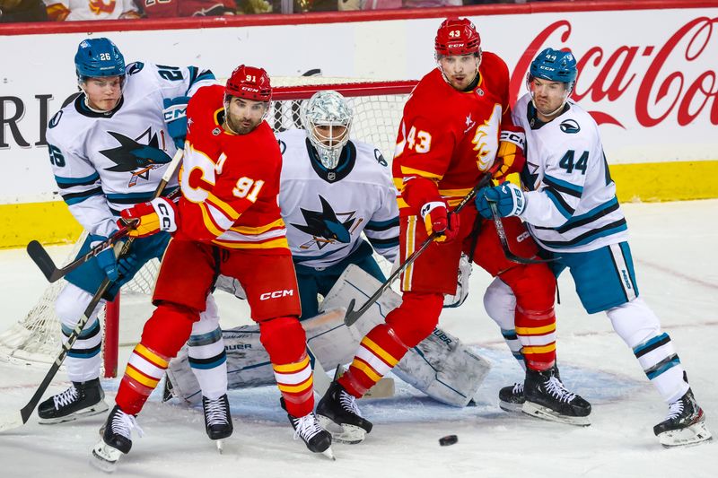 Apr 13, 2025; Calgary, Alberta, CAN; Calgary Flames center Nazem Kadri (91) and right wing Adam Klapka (43) screens in front of San Jose Sharks goaltender Georgi Romanov (31) during the first period at Scotiabank Saddledome. Mandatory Credit: Sergei Belski-Imagn Images