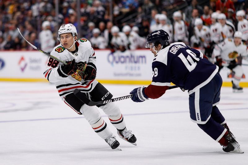 Oct 28, 2024; Denver, Colorado, USA; Chicago Blackhawks center Connor Bedard (98) and Colorado Avalanche defenseman Samuel Girard (49) in the third period at Ball Arena. Mandatory Credit: Isaiah J. Downing-Imagn Images