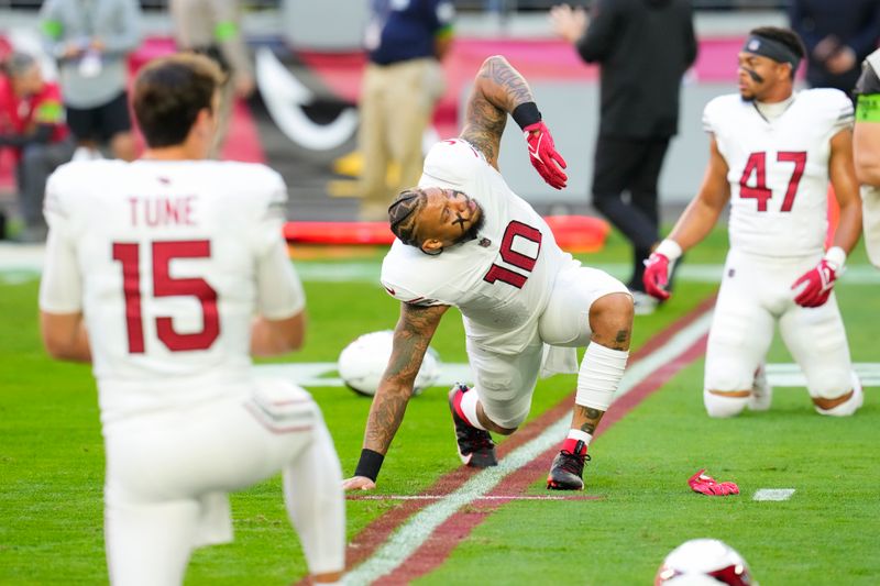 Arizona Cardinals linebacker Josh Woods (10) warms up before an NFL football game against the San Francisco 49ers Sunday, Dec. 17, 2023, in Glendale, Ariz. (AP Photo/Ross D. Franklin)