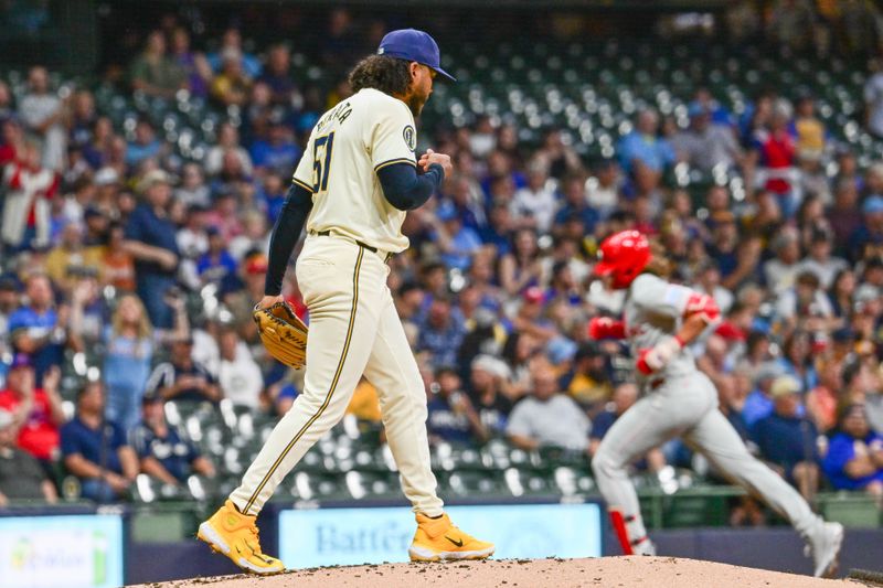 Sep 18, 2024; Milwaukee, Wisconsin, USA; Milwaukee Brewers starting pitcher Freddy Peralta (51) watches Philadelphia Phillies third baseman Alec Bohm (28) run the bases after hitting a solo home run in the second inning at American Family Field. Mandatory Credit: Benny Sieu-Imagn Images