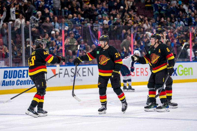 Dec 6, 2024; Vancouver, British Columbia, CAN; Vancouver Canucks forward Pius Suter (24) celebrates scoring with defenseman Quinn Hughes (43) and forward Brock Boeser (6) and defenseman Tyler Myers (57) against the Columbus Blue Jackets during the third period at Rogers Arena. Mandatory Credit: Bob Frid-Imagn Images