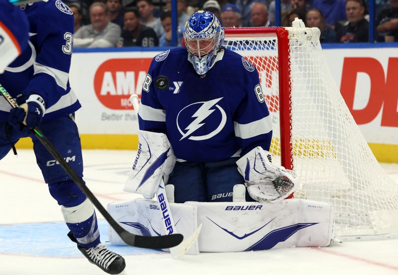 Nov 20, 2025; Tampa, Florida, USA;  Tampa Bay Lightning goaltender Andrei Vasilevskiy (88) defends the puck against the Edmonton Oilers during the second period at Benchmark International Arena. Mandatory Credit: Kim Klement Neitzel-Imagn Images