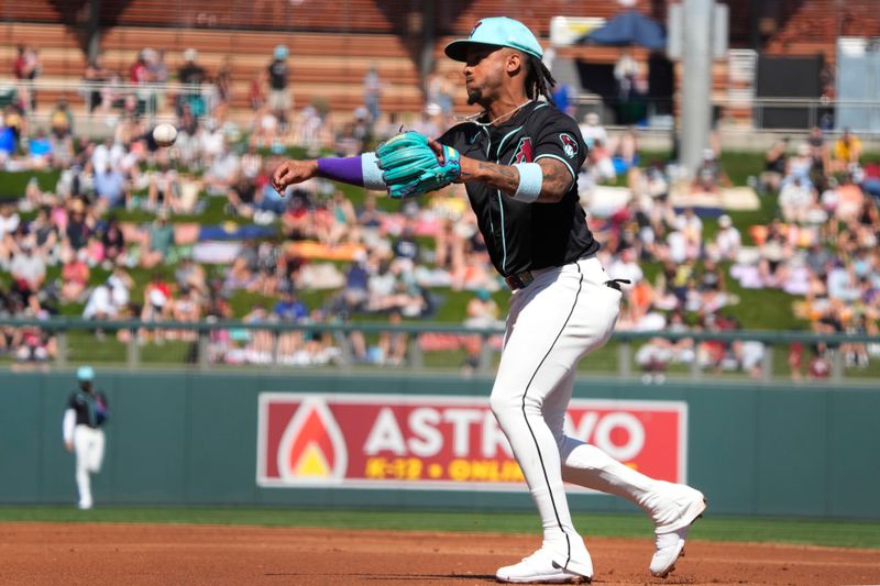 Mar 11, 2024; Salt River Pima-Maricopa, Arizona, USA; Arizona Diamondbacks second baseman Ketel Marte (4) throws to first base against the Oakland Athletics in the second inning at Salt River Fields at Talking Stick. Mandatory Credit: Rick Scuteri-USA TODAY Sports