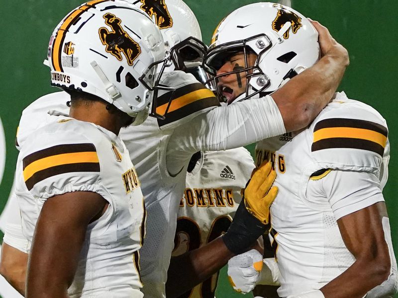 Nov 12, 2022; Fort Collins, Colorado, USA; Wyoming Cowboys wide receiver Alex Brown (9) celebrates his game-winning touchdown with teammates at Sonny Lubick Field at Canvas Stadium. Mandatory Credit: Michael Madrid-USA TODAY Sports