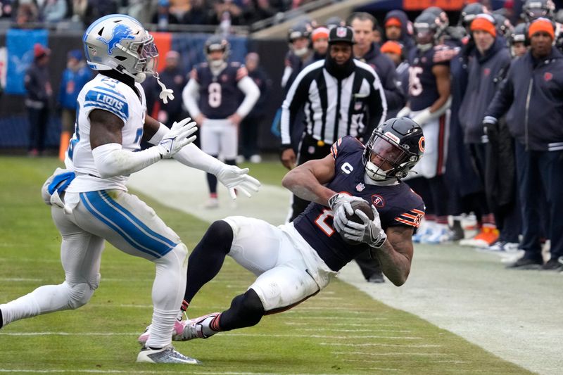 Chicago Bears wide receiver DJ Moore catches a pass from quarterback Justin Fields as Detroit Lions' Jerry Jacobs defends during the second half of an NFL football game Sunday, Dec. 10, 2023, in Chicago. (AP Photo/Nam Y. Huh)