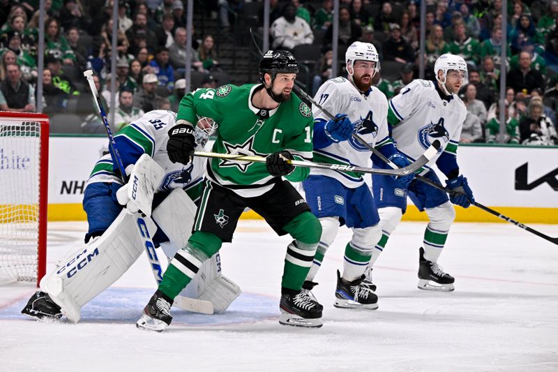 Jan 31, 2025; Dallas, Texas, USA; Vancouver Canucks goaltender Thatcher Demko (35) and defenseman Filip Hronek (17) and Dallas Stars left wing Jamie Benn (14) look for the puck in the Canucks zone during the second period at the American Airlines Center. Mandatory Credit: Jerome Miron-Imagn Images