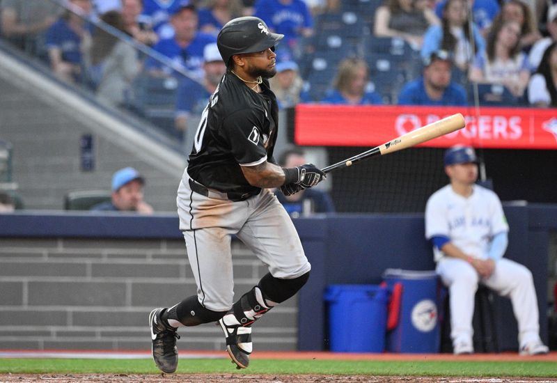 May 21, 2024; Toronto, Ontario, CAN;   Chicago White Sox right fielder Corey Julks (30) hits a two RBI single against the Toronto Blue Jays in the fifth inning at Rogers Centre. Mandatory Credit: Dan Hamilton-USA TODAY Sports