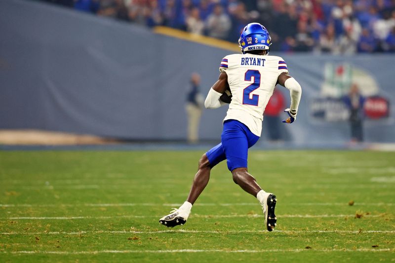 Dec 26, 2023; Phoenix, AZ, USA; Kansas Jayhawks cornerback Cobee Bryant (2) runs with the ball after an interception during the second quarter against the UNLV Rebels in the Guaranteed Rate Bowl at Chase Field. Mandatory Credit: Mark J. Rebilas-USA TODAY Sports