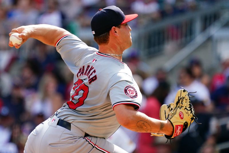 May 27, 2024; Cumberland, Georgia, USA; Washington Nationals pitcher Mitchell Parker (70) fires off a pitch against the Atlanta Braves during the second inning at Truist Park. Mandatory Credit: John David Mercer-USA TODAY Sports