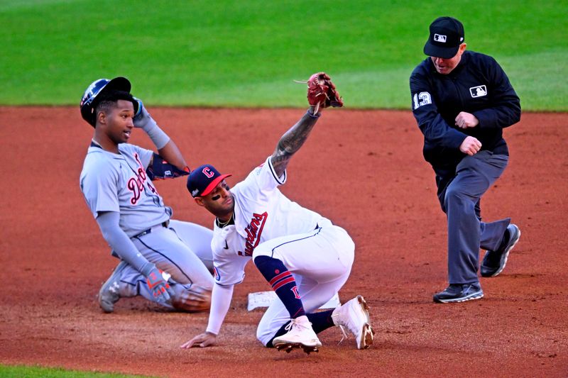 Oct 7, 2024; Cleveland, Ohio, USA; Cleveland Guardians shortstop Brayan Rocchio (4) tags outs Detroit Tigers outfielder Justyn-Henry Malloy (44) at second base during the fifth inning during game two of the ALDS for the 2024 MLB Playoffs at Progressive Field. Mandatory Credit: David Richard-Imagn Images