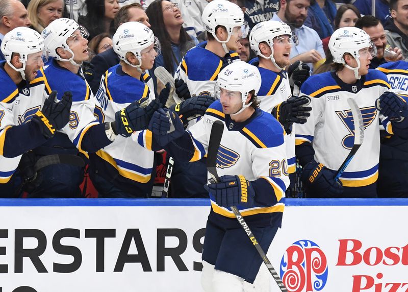 Jan 3, 2023; Toronto, Ontario, CAN; St. Louis Blues forward Brandon Saad (20) celebrates at the bench with teammates after scoring against the Toronto Maple Leafs in the first period at Scotiabank Arena. Mandatory Credit: Dan Hamilton-USA TODAY Sports