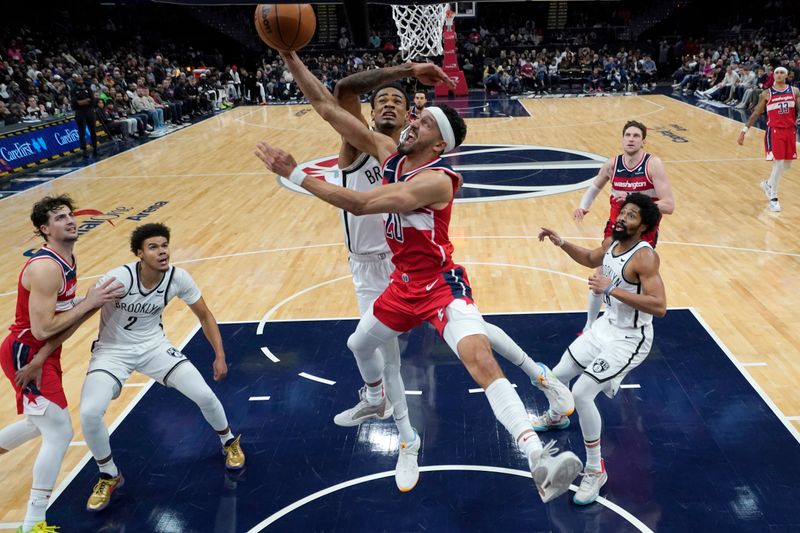 WASHINGTON, DC - DECEMBER 29: Landry Shamet #20 of the Washington Wizards goes up against Nic Claxton #33 of the Brooklyn Nets during the second half at Capital One Arena on December 29, 2023 in Washington, DC. NOTE TO USER: User expressly acknowledges and agrees that, by downloading and or using this photograph, User is consenting to the terms and conditions of the Getty Images License Agreement. (Photo by Jess Rapfogel/Getty Images)