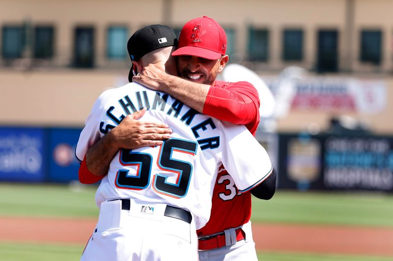 Feb 26, 2023; Jupiter, Florida, USA; St. Louis Cardinals manager Oliver Marmol (37) greets Miami Marlins manager Skip Shumaker (55) at Roger Dean Stadium. Mandatory Credit: Rhona Wise-USA TODAY Sports