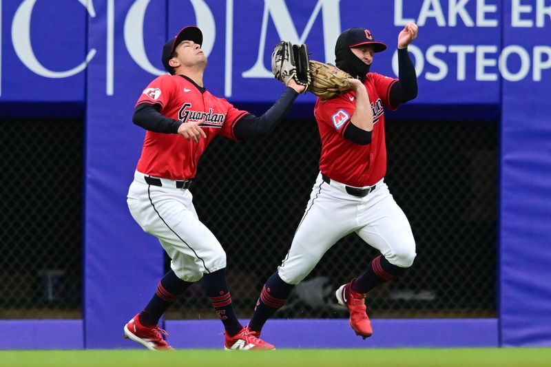 Apr 24, 2024; Cleveland, Ohio, USA; Cleveland Guardians center fielder Tyler Freeman, left, catches a ball hit by Boston Red Sox first baseman Bobby Dalbec (not pictured) while almost colliding with right fielder Will Brennan, right, during the fourth inning at Progressive Field. Mandatory Credit: Ken Blaze-USA TODAY Sports