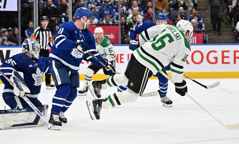 Feb 7, 2024; Toronto, Ontario, CAN; Toronto Maple Leafs forward Max Domi (11) pushes Dallas Stars forward Joe Pavelski (16) away from goalie Ilya Samsonov's goal area in the second period at Scotiabank Arena. Mandatory Credit: Dan Hamilton-USA TODAY Sports