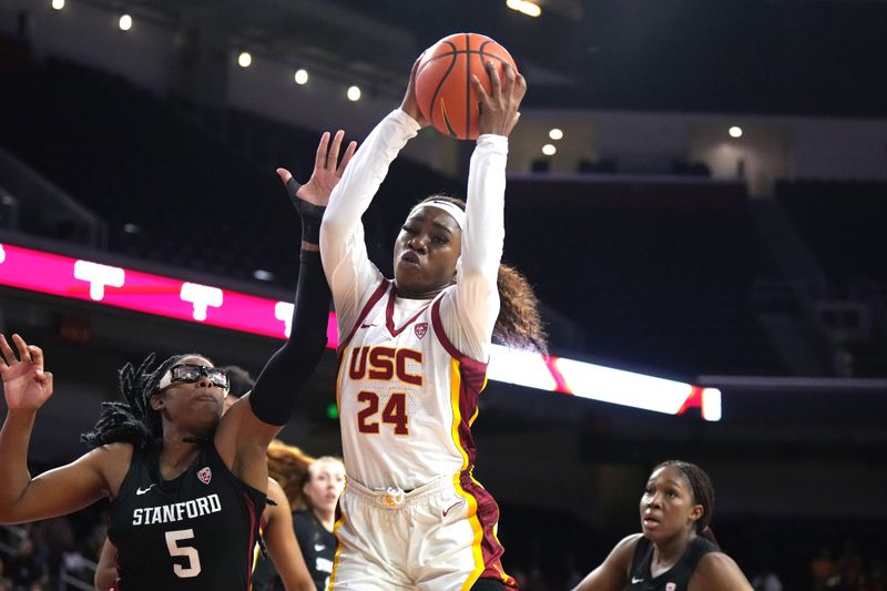 Jan 15, 2023; Los Angeles, California, USA; Southern California Trojans forward Okako Adika (24) rebounds the ball against Stanford Cardinal forward Francesca Belibi (5) in the first half at Galen Center.  USC defeated Stanford 55-46. Mandatory Credit: Kirby Lee-USA TODAY Sports