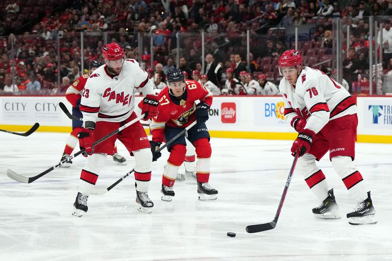 Nov 10, 2023; Sunrise, Florida, USA; Carolina Hurricanes defenseman Brady Skjei (76) plays the puck against the Florida Panthers during the second period at Amerant Bank Arena. Mandatory Credit: Jasen Vinlove-USA TODAY Sports