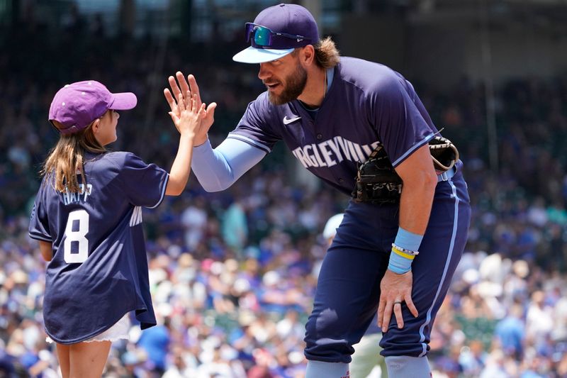Jun 21, 2024; Chicago, Illinois, USA; Chicago Cubs first baseman Patrick Wisdom (16) high fives a fan before the game against the New York Mets at Wrigley Field. Mandatory Credit: David Banks-USA TODAY Sports