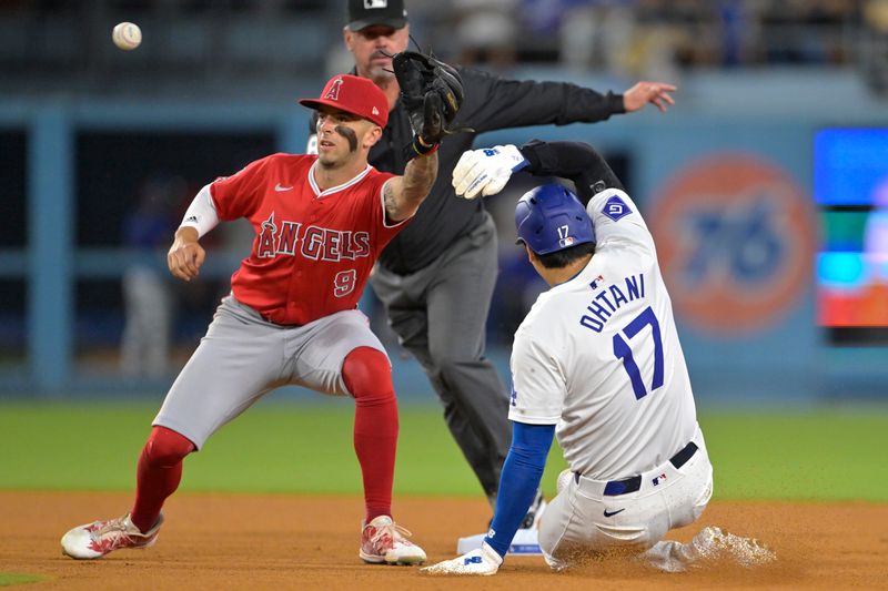 Jun 21, 2024; Los Angeles, California, USA;  Los Angeles Dodgers designated hitter Shohei Ohtani (17) is tagged out by Los Angeles Angels shortstop Zach Neto (9) on an attempted stolen base in the eighth inning at Dodger Stadium. Mandatory Credit: Jayne Kamin-Oncea-USA TODAY Sports