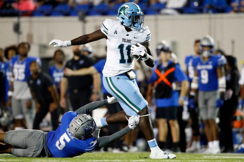 Oct 13, 2023; Memphis, Tennessee, USA; Tulane Green Wave tight end Chris Carter (11) runs after a catch as Memphis Tigers defensive back Simeon Blair (5) attempts to make the tackle during the second half at Simmons Bank Liberty Stadium. Mandatory Credit: Petre Thomas-USA TODAY Sports