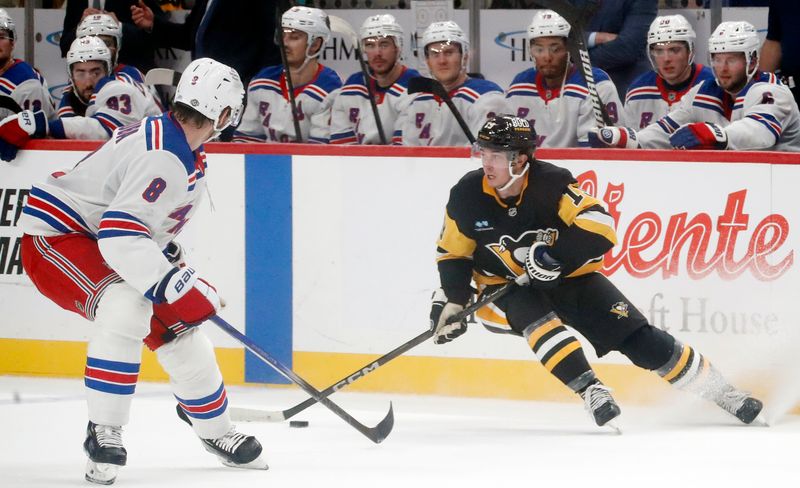 Oct 9, 2024; Pittsburgh, Pennsylvania, USA;  Pittsburgh Penguins center Cody Glass (19) handles the puck against Pittsburgh Penguins left wing Michael Bunting (8) during the third period at PPG Paints Arena. Mandatory Credit: Charles LeClaire-Imagn Images