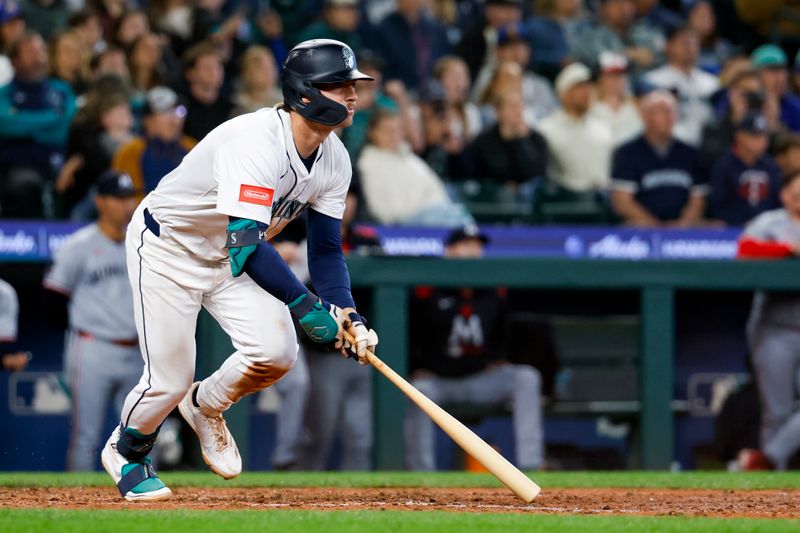 May 31, 2025; Seattle, Washington, USA; Seattle Mariners second baseman Cole Young (2) hits a single against the Minnesota Twins during the ninth inning at T-Mobile Park. The hit was the first career Major League hit by Young. Mandatory Credit: Joe Nicholson-Imagn Images