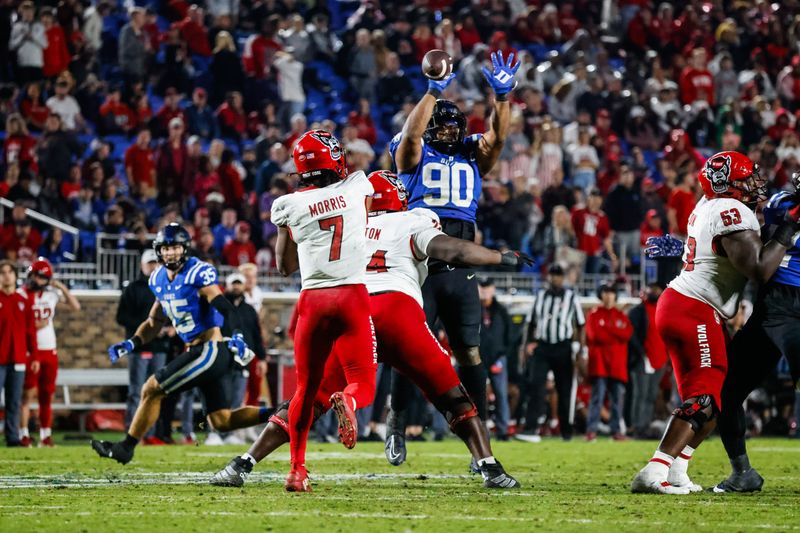 Oct 14, 2023; Durham, North Carolina, USA; Duke Blue Devils defensive tackle DeWayne Carter (90) tries to block North Carolina State Wolfpack quarterback MJ Morris (7) throw during the second half of the game against at Wallace Wade Stadium. Mandatory Credit: Jaylynn Nash-USA TODAY Sports