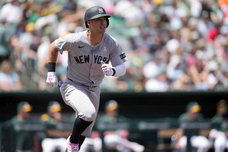 May 11, 2025; West Sacramento, California, USA; New York Yankees shortstop Anthony Volpe (11) hits an RBI single against the Athletics in the second inning at Sutter Health Park. Mandatory Credit: Cary Edmondson-Imagn Images