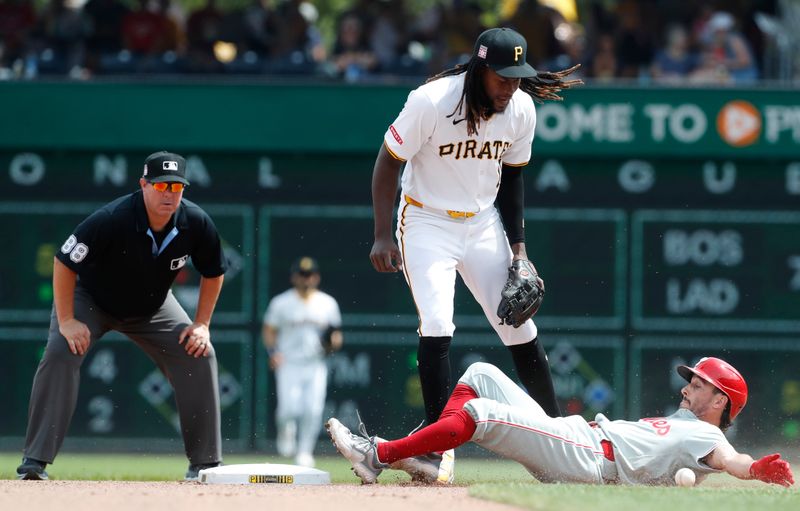 Jul 21, 2024; Pittsburgh, Pennsylvania, USA;  Pittsburgh Pirates shortstop Oneil Cruz (15) drops a throw at second base for an error and allowing catcher Garrett Stubbs (21) to arrive safely and a Philadelphia Phillies run to score during the seventh inning at PNC Park. The Phillies won 6-0. Mandatory Credit: Charles LeClaire-USA TODAY Sports