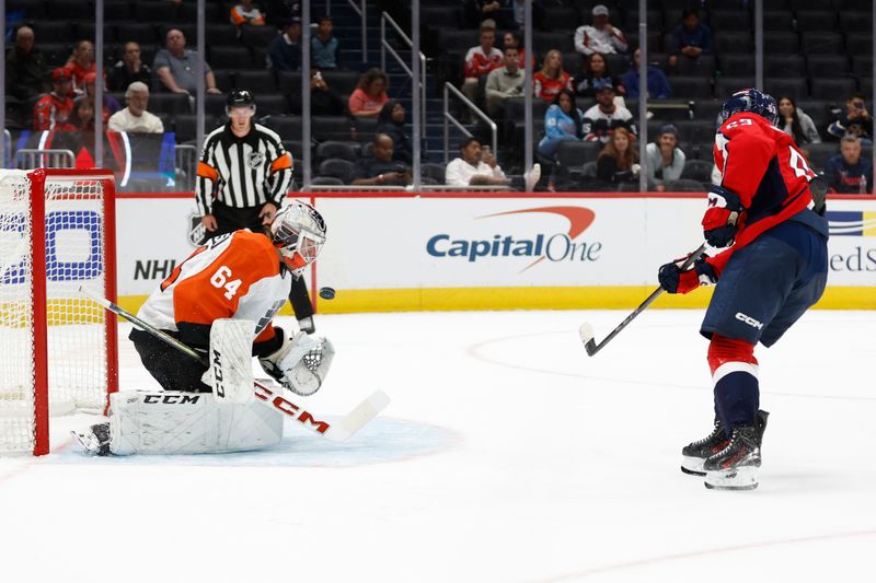 Sep 22, 2024; Washington, District of Columbia, USA; Philadelphia Flyers goaltender Carson Bjarnason (64) makes a save on Washington Capitals forward Ivan Miroshnichenko (63) in a shootout at Capital One Arena. Mandatory Credit: Geoff Burke-Imagn Images