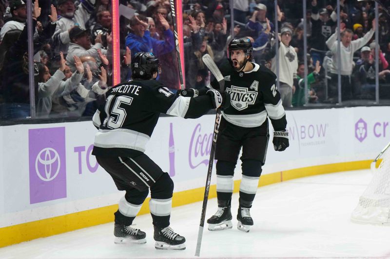 Nov 27, 2024; Los Angeles, California, USA; LA Kings center Phillip Danault (24) and center Alex Turcotte (15) celebrate after a goal against the Winnipeg Jets in the second period at Crypto.com Arena. Mandatory Credit: Kirby Lee-Imagn Images