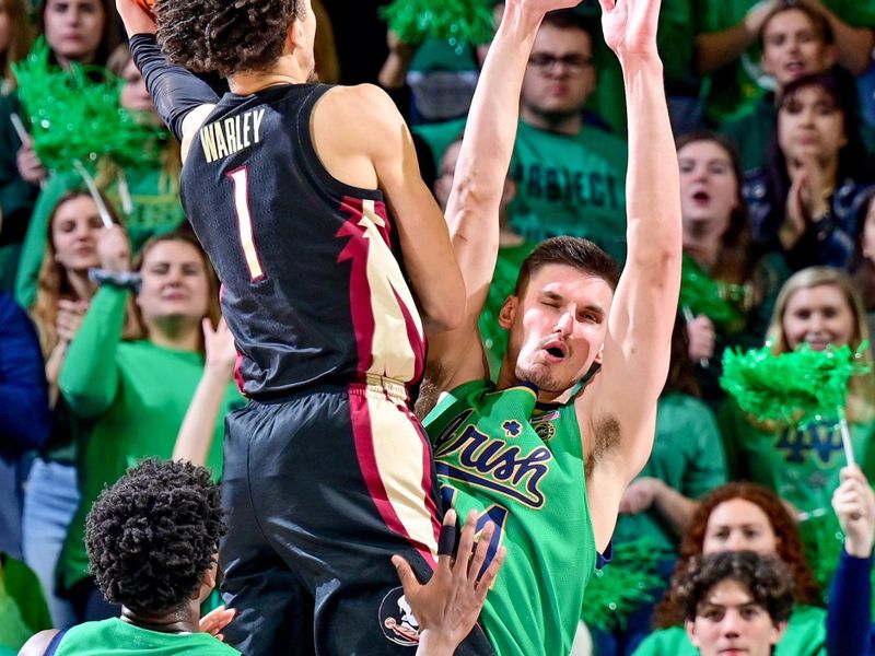 Jan 17, 2023; South Bend, Indiana, USA; Florida State Seminoles guard Jalen Warley (1) goes up for a shot as Notre Dame Fighting Irish forward Nate Laszewski (14) defends in the second half at the Purcell Pavilion. Mandatory Credit: Matt Cashore-USA TODAY Sports