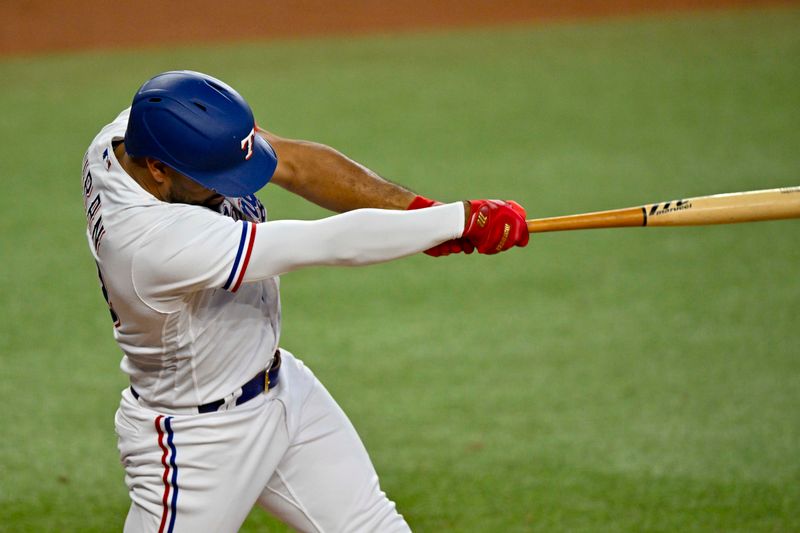 Aug 3, 2023; Arlington, Texas, USA; Texas Rangers pinch hitter Ezequiel Duran (20) hits a single against the Chicago White Sox during the eighth inning at Globe Life Field. Mandatory Credit: Jerome Miron-USA TODAY Sports