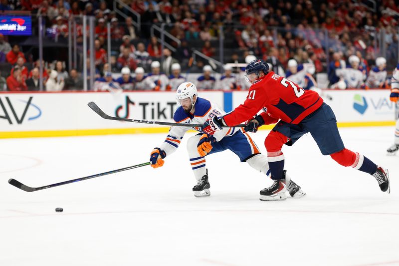Nov 19, 2025; Washington, District of Columbia, USA; Washington Capitals center Aliaksei Protas (21) and Edmonton Oilers right wing David Tomasek (86) battle for the puck during the third period at Capital One Arena. Mandatory Credit: Geoff Burke-Imagn Images