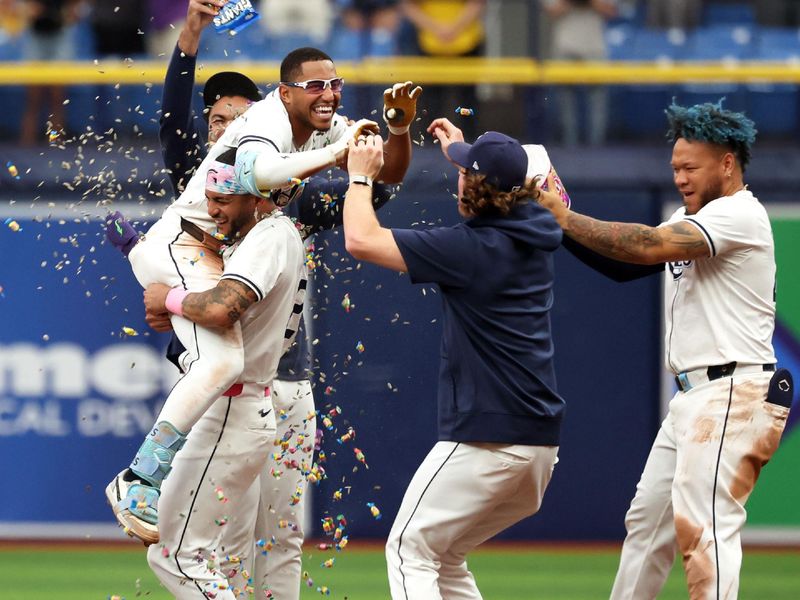 May 30, 2024; St. Petersburg, Florida, USA; Tampa Bay Rays outfielder Richie Palacios (1) celebrates with outfielder Jose Siri (22) and teammates after hitting a walk off RBI single against the Oakland Athletics during the eleventh inning at Tropicana Field. Mandatory Credit: Kim Klement Neitzel-USA TODAY Sports