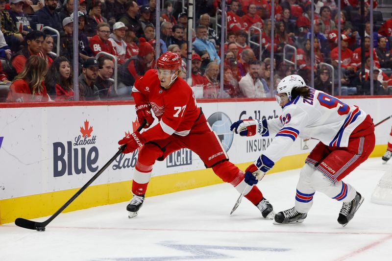 Oct 17, 2024; Detroit, Michigan, USA;  Detroit Red Wings defenseman Simon Edvinsson (77) skates with the puck in the first period against the New York Rangers at Little Caesars Arena. Mandatory Credit: Rick Osentoski-Imagn Images