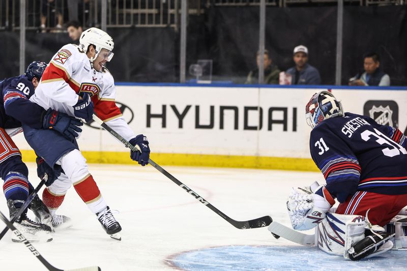 Oct 24, 2024; New York, New York, USA;  New York Rangers goaltender Igor Shesterkin (31) defends against a shot on goal attempt by Florida Panthers center Carter Verhaeghe (23) in the first period against the New York Rangers at Madison Square Garden. Mandatory Credit: Wendell Cruz-Imagn Images