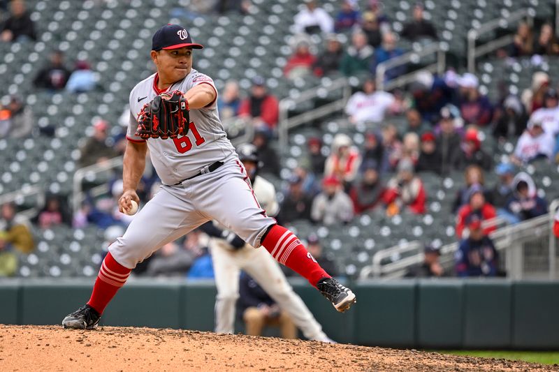 Apr 23, 2023; Minneapolis, Minnesota, USA;  Washington Nationals pitcher Erasmo Ramirez (61) delivers against the Minnesota Twins at Target Field. Mandatory Credit: Nick Wosika-USA TODAY Sports