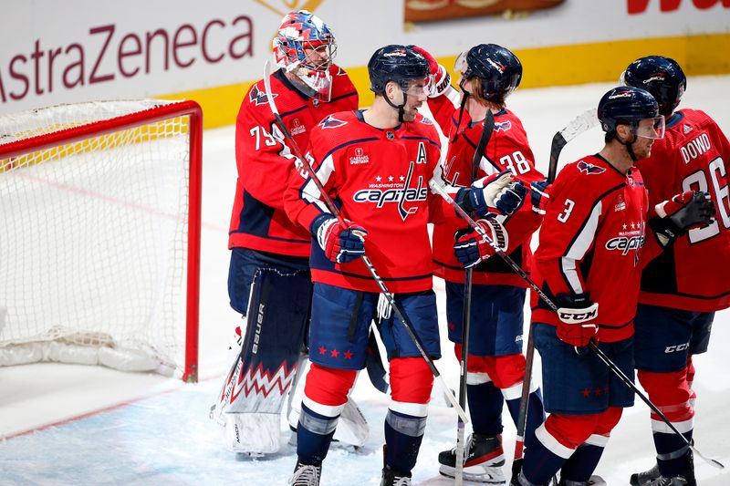 Nov 18, 2023; Washington, District of Columbia, USA; Washington Capitals goaltender Charlie Lindgren (79) celebrates with teammates after defeating the Columbus Blue Jackets during the third period at Capital One Arena. Mandatory Credit: Amber Searls-USA TODAY Sports