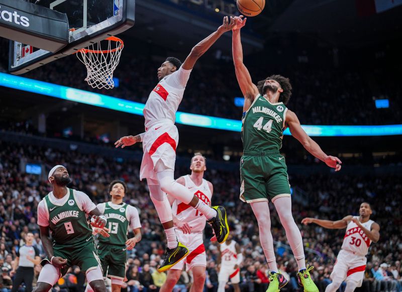 TORONTO, ON - JANUARY 06: Andre Jackson Jr. #44 of the Milwaukee Bucks blocks RJ Barrett #9 of the Toronto Raptors during the second half at the Scotiabank Arena on January 6, 2025 in Toronto, Ontario, Canada. NOTE TO USER: User expressly acknowledges and agrees that, by downloading and/or using this Photograph, user is consenting to the terms and conditions of the Getty Images License Agreement. (Photo by Kevin Sousa/Getty Images)