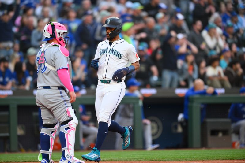 May 10, 2025; Seattle, Washington, USA; Seattle Mariners center fielder Julio Rodriguez (44) scores a run against the Toronto Blue Jays during the fourth inning at T-Mobile Park. Mandatory Credit: Steven Bisig-Imagn Images