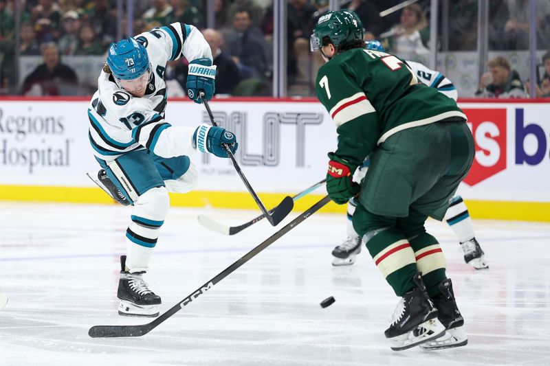 Oct 26, 2025; Saint Paul, Minnesota, USA; San Jose Sharks center Tyler Toffoli (73) shoots the puck as Minnesota Wild defenseman Brock Faber (7) defends during the second period at Grand Casino Arena. Mandatory Credit: Matt Krohn-Imagn Images