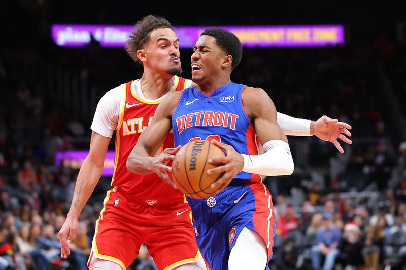 ATLANTA, GEORGIA - DECEMBER 18:  Jaden Ivey #23 of the Detroit Pistons drives against Trae Young #11 of the Atlanta Hawks during the fourth quarter at State Farm Arena on December 18, 2023 in Atlanta, Georgia.  NOTE TO USER: User expressly acknowledges and agrees that, by downloading and/or using this photograph, user is consenting to the terms and conditions of the Getty Images License Agreement.  (Photo by Kevin C. Cox/Getty Images)