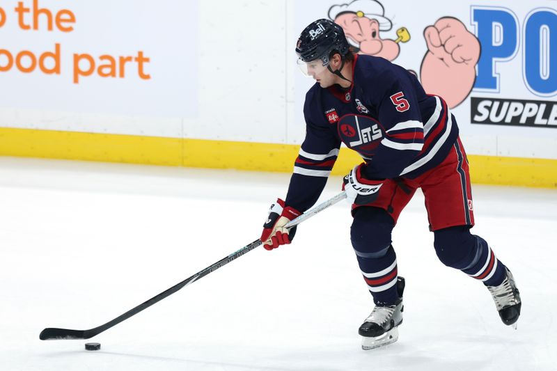 Dec 9, 2025; Winnipeg, Manitoba, CAN; Winnipeg Jets defenseman Luke Schenn (5) warms up before a game against the Dallas Stars at Canada Life Centre. Mandatory Credit: James Carey Lauder-Imagn Images