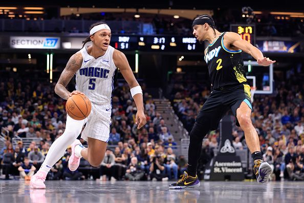 INDIANAPOLIS, INDIANA - DECEMBER 23: Paolo Banchero #5 of the Orlando Magic drives to the basket while defended by Andrew Nembhard #2 of the Indiana Pacers during the first half at Gainbridge Fieldhouse on December 23, 2023 in Indianapolis, Indiana. NOTE TO USER: User expressly acknowledges and agrees that, by downloading and or using this photograph, User is consenting to the terms and conditions of the Getty Images License Agreement. (Photo by Justin Casterline/Getty Images)