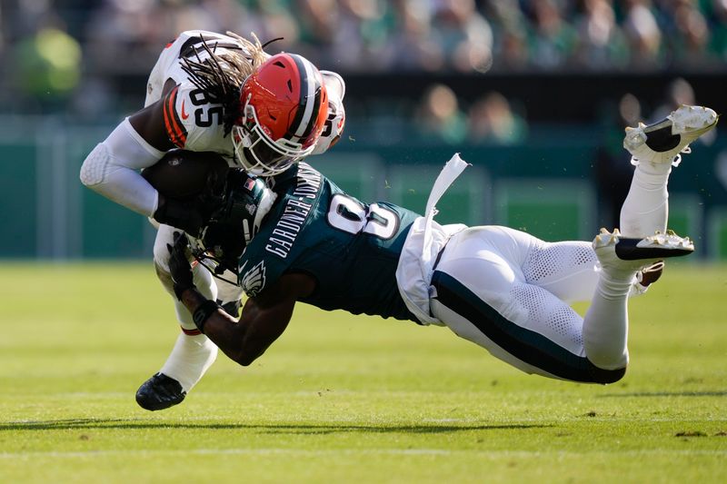 Philadelphia Eagles safety C.J. Gardner-Johnson (8) stops Cleveland Browns tight end David Njoku (85) during the second half of an NFL football game Sunday, Oct. 13, 2024, in Philadelphia. (AP Photo/Matt Rourke)