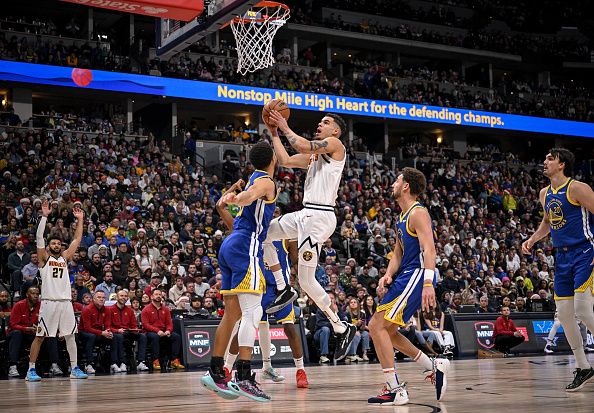 DENVER, CO - DECEMBER 25: Michael Porter Jr. (1) of the Denver Nuggets drives to the cup for a layup over Stephen Curry (30) of the Golden State Warriors during the fourth quarter of the Nuggets' 120-114 win at Ball Arena in Denver on Monday, December 25, 2023. (Photo by AAron Ontiveroz/The Denver Post)