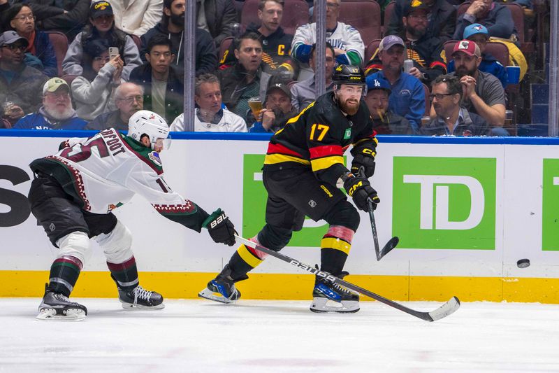 Apr 10, 2024; Vancouver, British Columbia, CAN; Vancouver Canucks defenseman Filip Hronek (17) passes over the stick of Arizona Coyotes forward Alex Kerfoot (15) in the third period at Rogers Arena. Arizona won 4-3 in overtime. Mandatory Credit: Bob Frid-USA TODAY Sports