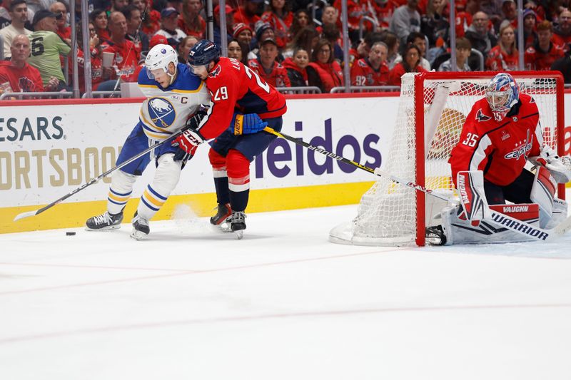 Nov 22, 2023; Washington, District of Columbia, USA; Buffalo Sabres right wing Kyle Okposo (21) and Washington Capitals center Hendrix Lapierre (29) battle for the puck in the second period at Capital One Arena. Mandatory Credit: Geoff Burke-USA TODAY Sports